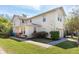 Stunning two-story townhouse with a well-maintained lawn and a paved walkway at 5565 Gelato Dr, Orlando, FL 32829