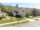 A well-maintained exterior of a townhome with a lush green lawn and lovely landscaping at 5565 Gelato Dr, Orlando, FL 32829