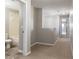 Hallway view with a bathroom, neutral paint, and plush carpeting at 5565 Gelato Dr, Orlando, FL 32829