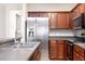 Updated kitchen showcases stainless steel appliances, modern cabinets, and granite countertops at 5565 Gelato Dr, Orlando, FL 32829
