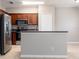Well-lit kitchen features stainless steel appliances, dark countertops, and ample cabinet space at 5565 Gelato Dr, Orlando, FL 32829