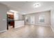 Open-concept living area with tile flooring, stainless steel appliances, and natural light at 5565 Gelato Dr, Orlando, FL 32829
