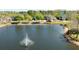 Scenic aerial view of a neighborhood pond, complete with a fountain in the center at 5565 Gelato Dr, Orlando, FL 32829
