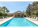 Community pool with lounge chairs, gazebo, and clear blue water at 5565 Gelato Dr, Orlando, FL 32829
