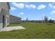 The ample backyard includes a concrete patio and lush lawn. Perfect for entertaining or relaxing outdoors at 640 Trotters Dr, Eagle Lake, FL 33839