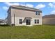 Enjoy the expansive yard of this home's backyard with siding, windows, and a sliding glass door at 640 Trotters Dr, Eagle Lake, FL 33839