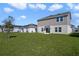 This home boasts a spacious, grassy backyard with a view of the home's exterior at 640 Trotters Dr, Eagle Lake, FL 33839