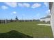 The backyard showcases a lush lawn, wood fence, and well-manicured landscaping at 640 Trotters Dr, Eagle Lake, FL 33839