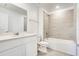 Bright bathroom features a shower over tub, sleek fixtures, and tiled floor at 640 Trotters Dr, Eagle Lake, FL 33839