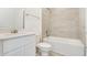 A well-lit bathroom with tiled shower, vanity, granite countertop, and fixtures at 640 Trotters Dr, Eagle Lake, FL 33839