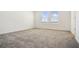 Spacious bedroom with soft carpet and natural light, perfect for relaxing and unwinding at 640 Trotters Dr, Eagle Lake, FL 33839
