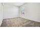 Carpeted bedroom boasts neutral decor, a bright window, and spacious design at 640 Trotters Dr, Eagle Lake, FL 33839