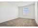 Bright bedroom with a neutral color scheme, plush carpet, and window at 640 Trotters Dr, Eagle Lake, FL 33839