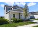 A view of the side of the house showcasing landscaping, and a driveway at 640 Trotters Dr, Eagle Lake, FL 33839