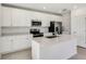 Beautiful kitchen with an island, stainless steel appliances, white cabinets, and plenty of counter space at 640 Trotters Dr, Eagle Lake, FL 33839