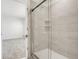 Contemporary shower with glass door and tiled walls, offering a clean and modern design at 640 Trotters Dr, Eagle Lake, FL 33839