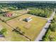 This aerial view of the property shows the home, shed, yard, and surrounding landscape at 6607 Whispering Pines Rd, Orlando, FL 32824