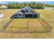 An exterior view of a home's fenced backyard and screened-in porch at 6607 Whispering Pines Rd, Orlando, FL 32824