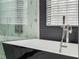 Close up of black and white soaking tub with tile surround at 6607 Whispering Pines Rd, Orlando, FL 32824