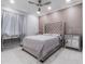 Chic bedroom with upholstered headboard, marble floors and mirrored accents at 6607 Whispering Pines Rd, Orlando, FL 32824