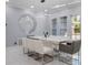 Elegant dining room featuring modern light fixture, decorative wall art, and large windows at 6607 Whispering Pines Rd, Orlando, FL 32824