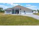 Charming single-story home featuring a three-car garage, paved driveway and a well-manicured lawn at 6607 Whispering Pines Rd, Orlando, FL 32824