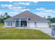 Beautiful single-story home featuring a three-car garage, water fountain, and a spacious front yard at 6607 Whispering Pines Rd, Orlando, FL 32824