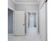 Hallway featuring white doors, trim and continuous marble flooring at 6607 Whispering Pines Rd, Orlando, FL 32824