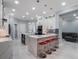 Open-concept kitchen featuring a large island with bar seating, modern appliances, and stylish design at 6607 Whispering Pines Rd, Orlando, FL 32824