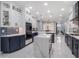 Spacious kitchen showcasing two-tone cabinets, a large island, and an open layout at 6607 Whispering Pines Rd, Orlando, FL 32824