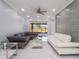 Bright living room with modern decor, featuring large windows and a stylish accent wall at 6607 Whispering Pines Rd, Orlando, FL 32824