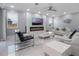 Cozy living room with modern fireplace, accent wall, stylish furniture, and white marble floors at 6607 Whispering Pines Rd, Orlando, FL 32824