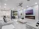 Open-concept living room featuring a fireplace, sleek furniture, and a seamless connection to the outdoors at 6607 Whispering Pines Rd, Orlando, FL 32824