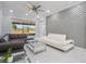 Spacious living room with designer sofas, glass coffee table, and stylish accent wall at 6607 Whispering Pines Rd, Orlando, FL 32824