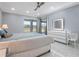 Bright main bedroom featuring marble floors, ensuite and ceiling fan at 6607 Whispering Pines Rd, Orlando, FL 32824