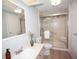 Bathroom with stylish sink, toilet, and glass shower with shower seat at 726 Viking Ave, Tavares, FL 32778