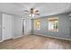 The bedroom features wood-look flooring, two windows, and a doorway, offering a light-filled space at 726 Viking Ave, Tavares, FL 32778