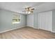 Bright bedroom with natural light, laminate flooring, neutral wall paint and ample closet space at 726 Viking Ave, Tavares, FL 32778