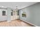 Dining area features neutral paint, flooring, a built-in cabinet, and a modern light fixture at 726 Viking Ave, Tavares, FL 32778