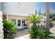 Charming home featuring tropical landscaping, a white trim, and neutral yellow siding at 726 Viking Ave, Tavares, FL 32778