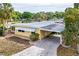 Charming yellow home boasts a convenient carport and well-maintained landscaping, nestled in a peaceful community at 726 Viking Ave, Tavares, FL 32778