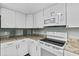 The kitchen boasts white cabinetry, ample counter space, and modern appliances for all cooking needs at 726 Viking Ave, Tavares, FL 32778