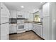Well-lit kitchen features white appliances, ample cabinet space, and modern countertops, perfect for cooking and entertaining at 726 Viking Ave, Tavares, FL 32778
