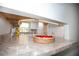Modern pass-through kitchen featuring white cabinetry and stone countertops at 726 Viking Ave, Tavares, FL 32778