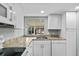 Close up on the kitchen featuring stainless steel sink, countertops and updated appliances and plenty of natural light at 726 Viking Ave, Tavares, FL 32778