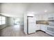 Open-concept kitchen and living room space with lots of natural light and laminate floors at 726 Viking Ave, Tavares, FL 32778