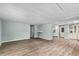 Open floor plan with laminate flooring, offering a seamless flow between the living, dining, and kitchen areas at 726 Viking Ave, Tavares, FL 32778