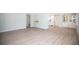 Spacious living area featuring laminate flooring, light-blue walls, and a view into the kitchen at 726 Viking Ave, Tavares, FL 32778