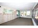 Relaxing living room with tropical mural, carpeted floor, and plenty of natural light at 726 Viking Ave, Tavares, FL 32778