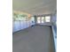 Large sunroom features an interesting mural and ample windows providing natural light at 726 Viking Ave, Tavares, FL 32778